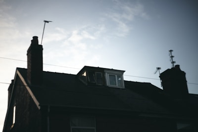 Golden Hands Roofing and Chimney truck parked outside a home at dusk.