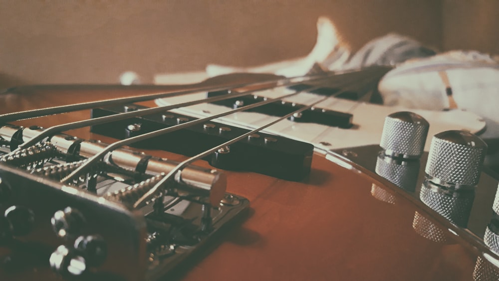 brown and white electric guitar