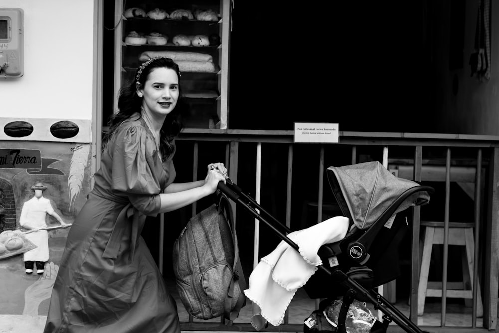 woman in gray coat standing beside black bicycle