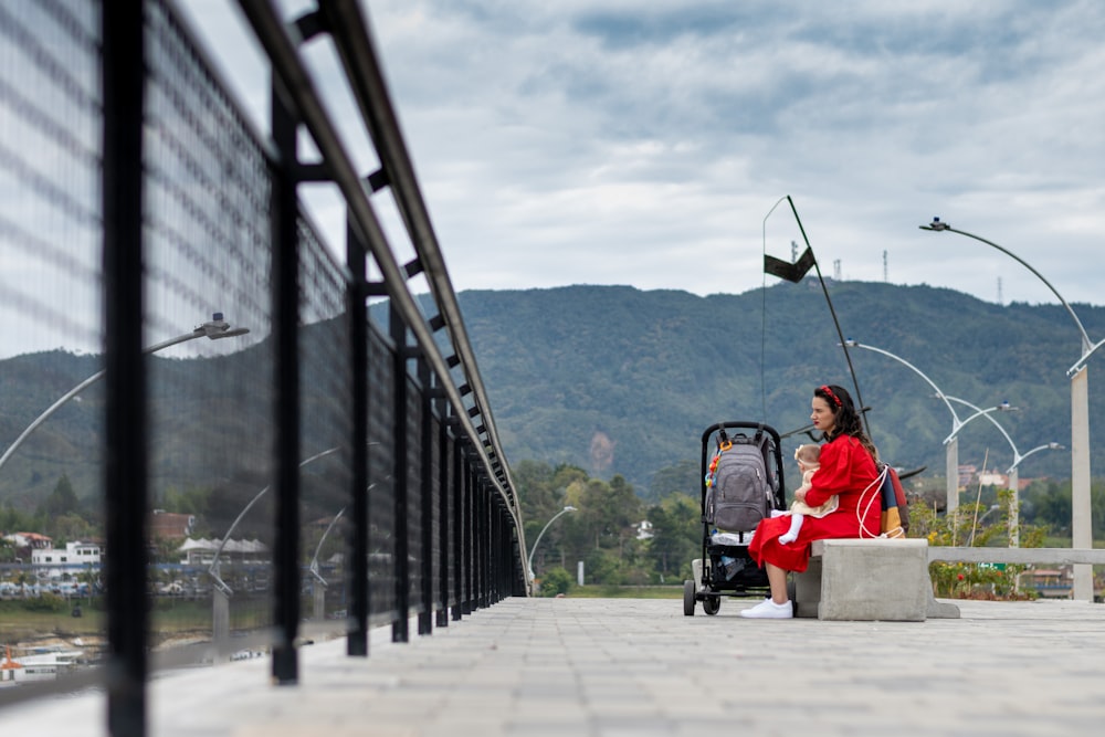 man in red jacket riding on black and red stroller