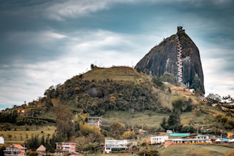 green and brown mountain under cloudy sky during daytime