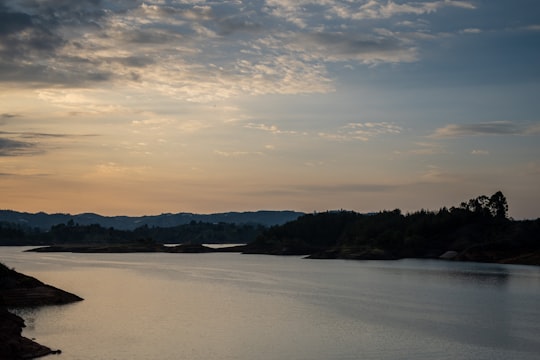 body of water near mountain during daytime in Guatape Colombia