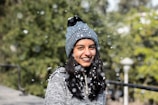 A cozy winter beanie in deep blue, surrounded by soft snowflakes.