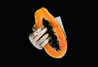 person holding orange and yellow fruit