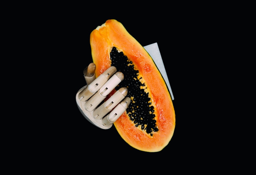 person holding orange and yellow fruit