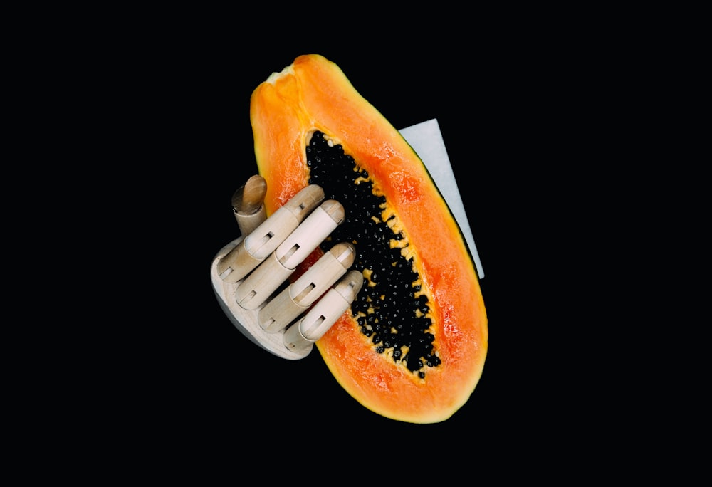 person holding orange and yellow fruit