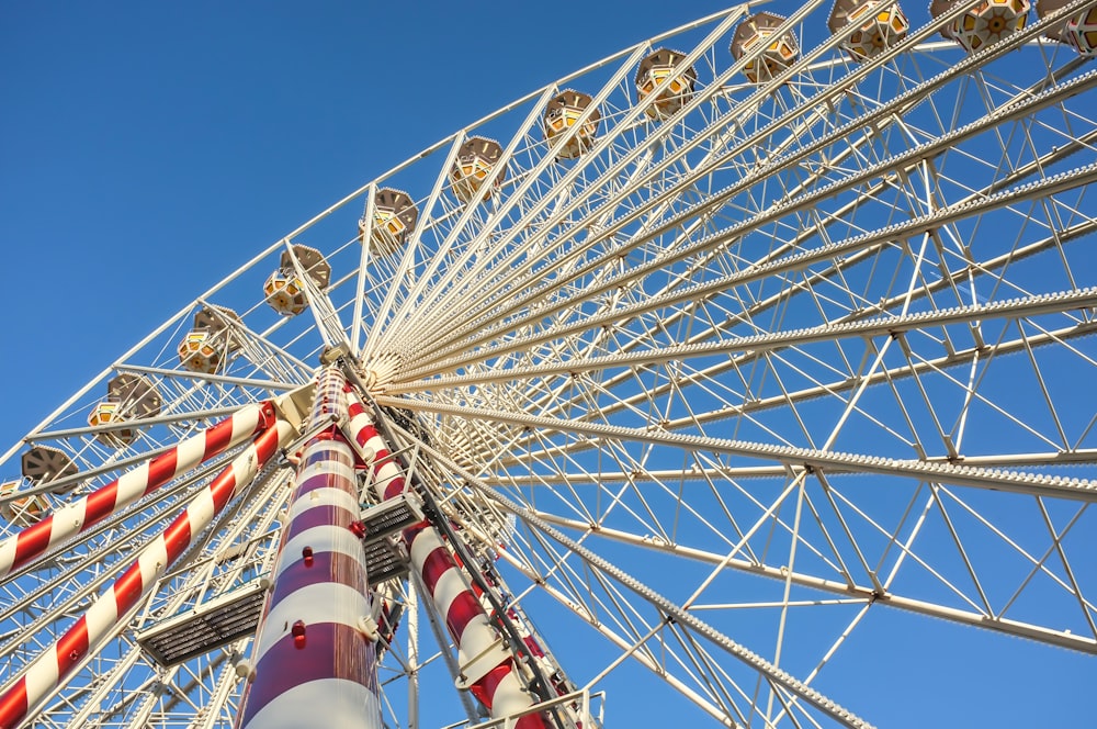 white and red ferris wheel under blue sky during daytime