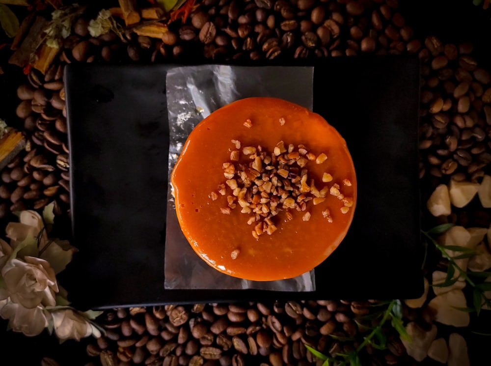 orange round fruit on black surface