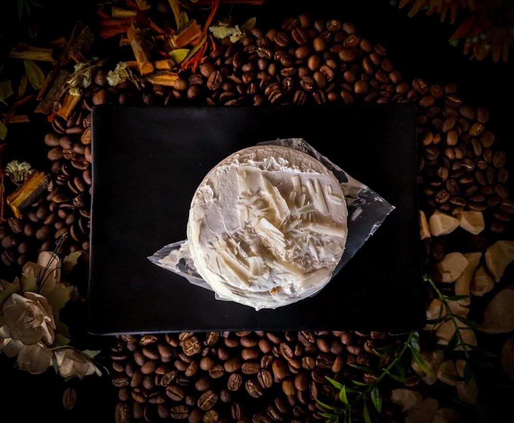 brown coffee beans on black ceramic plate