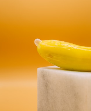 yellow banana fruit on white concrete post