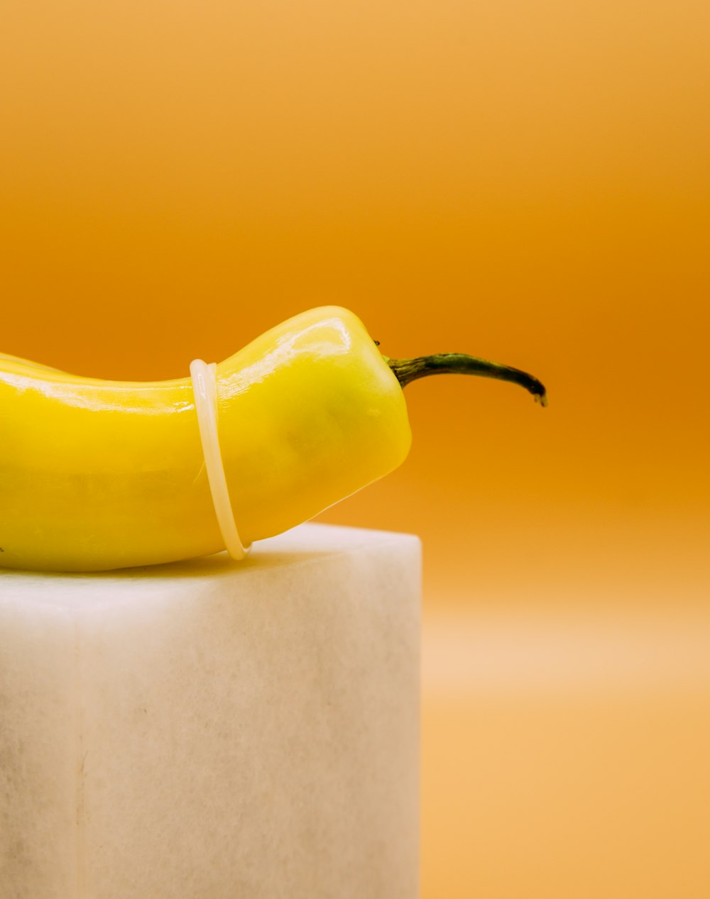 yellow bell pepper on white paper