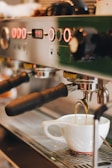 white ceramic mug on silver espresso machine