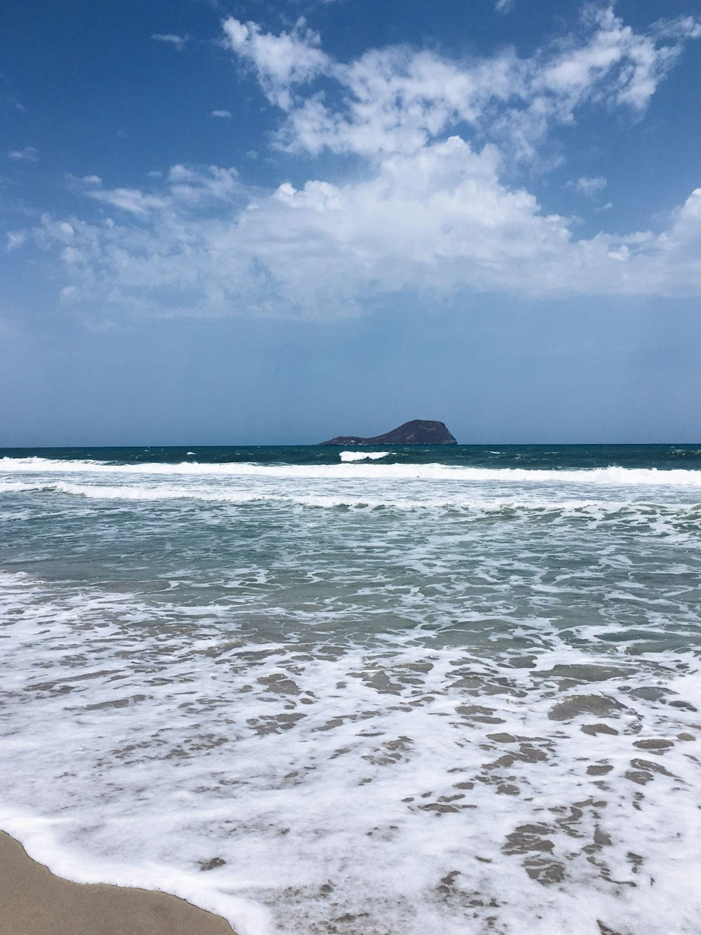 body of water under blue sky during daytime