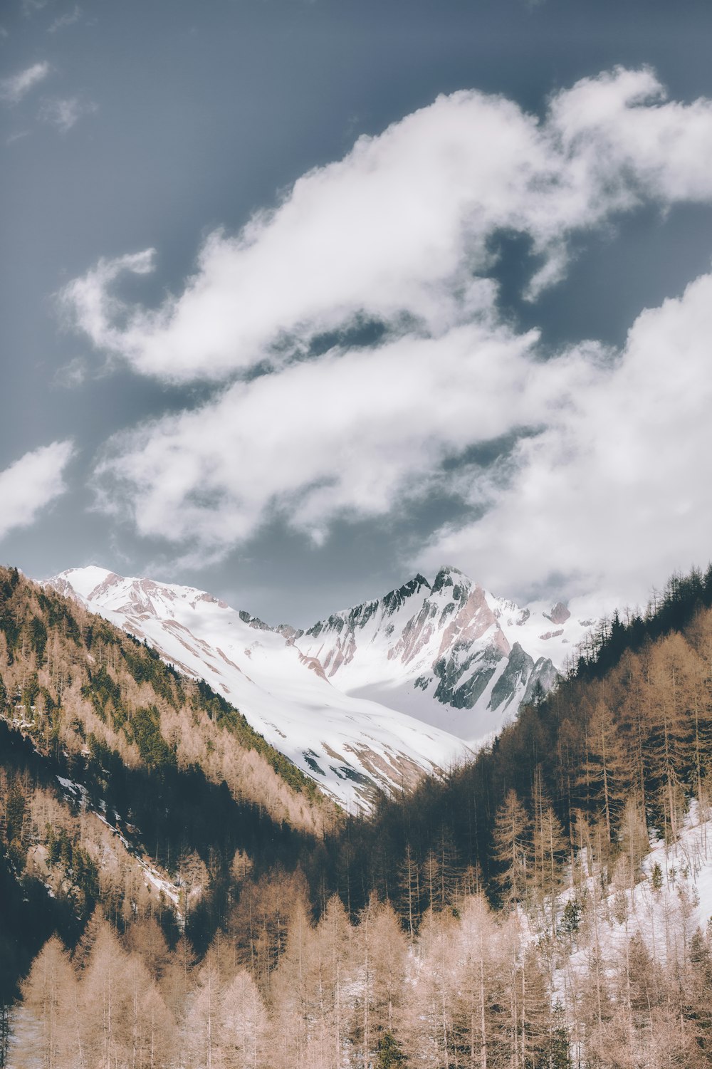 snow covered mountain under cloudy sky during daytime