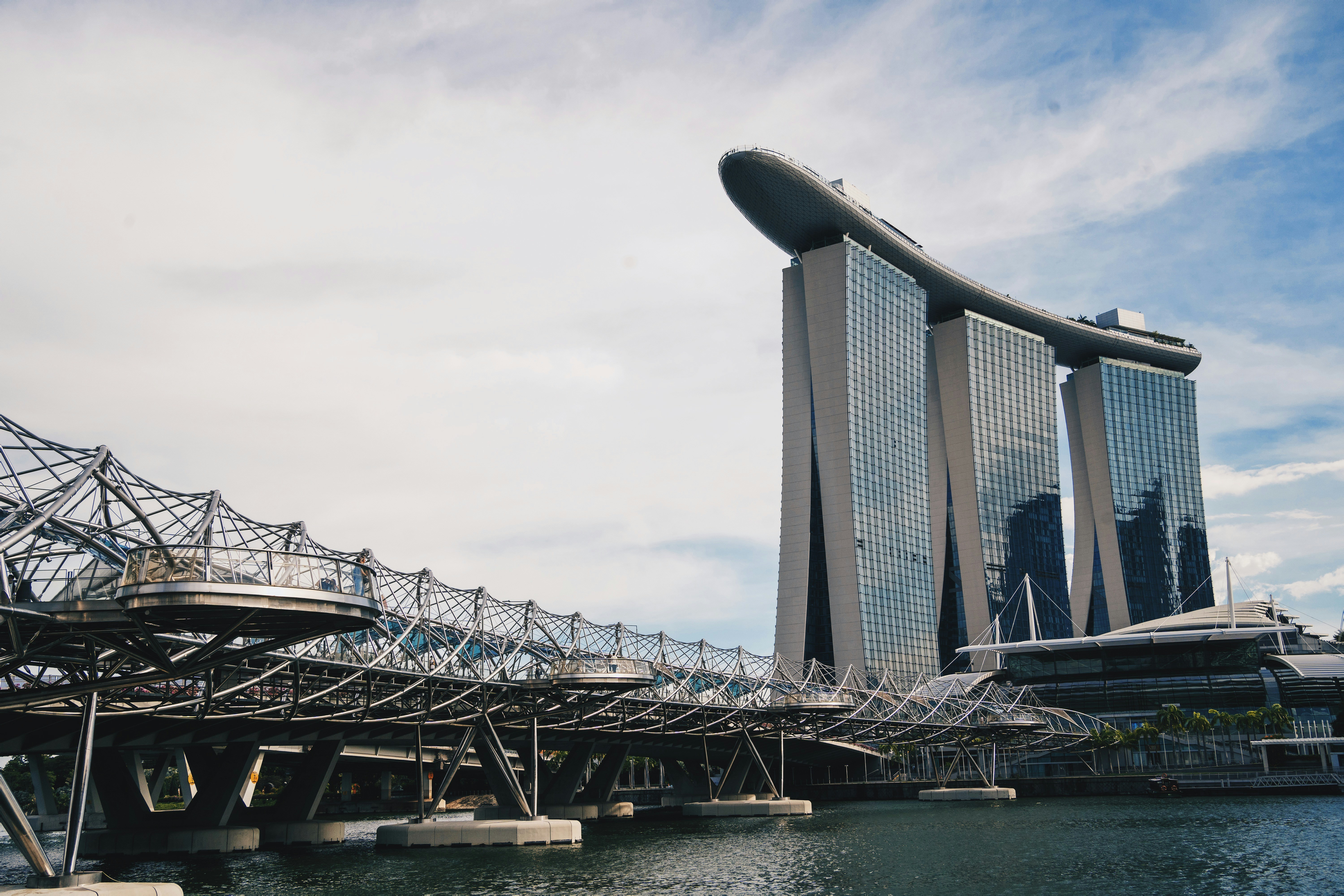 gray metal bridge under white clouds during daytime