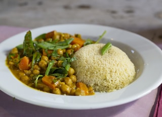 rice with green leaf vegetable on white ceramic plate