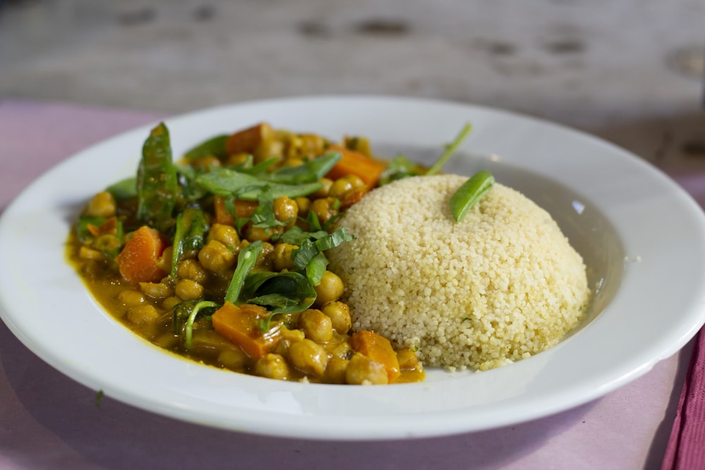 rice with green leaf vegetable on white ceramic plate