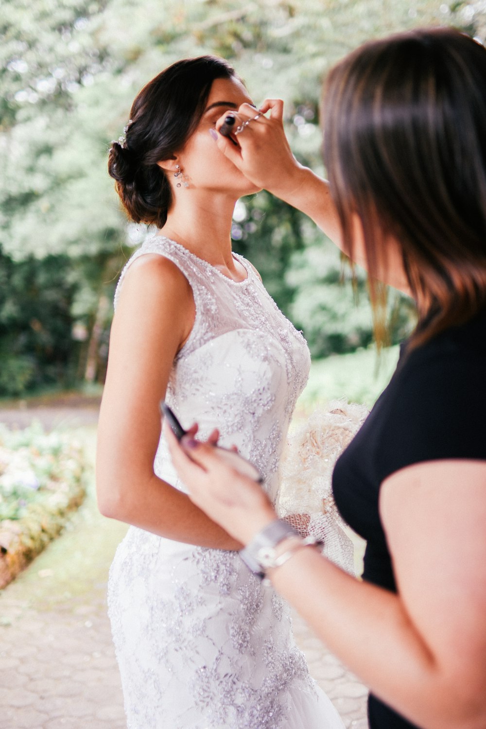 woman in white tank top holding smartphone