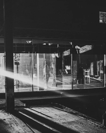 A sleek black and white photo of Robson Giubbina in a modern industrial setting.