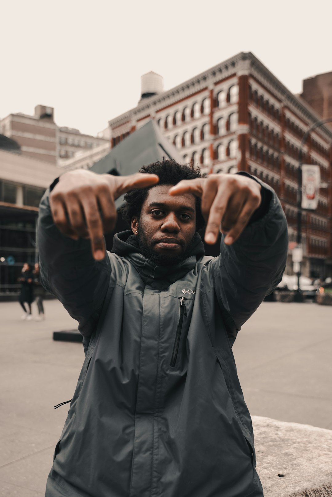 man in black leather jacket raising his hands