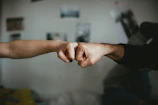 deux poings qui se rencontrent pour sceller un accord https://unsplash.com