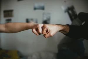 Close-up of hands shaking, symbolizing trust and commitment in business partnership.