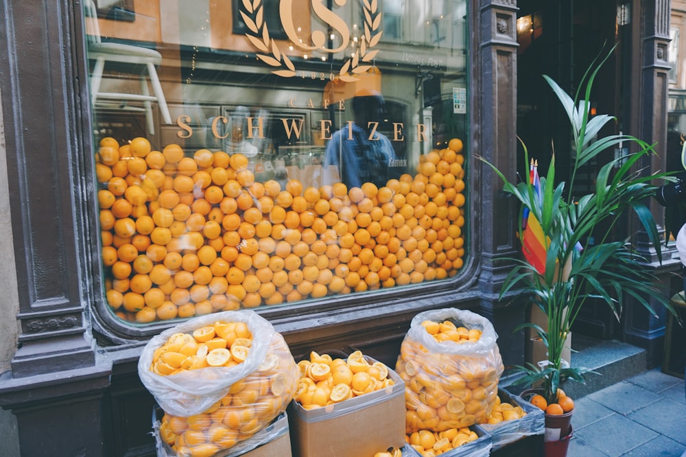 orange fruits on black plastic crate