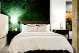 Elegant bedroom featuring terracotta accents and emerald green cushions.