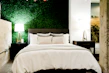 Cozy bedroom featuring warm textiles and subtle olive green accents