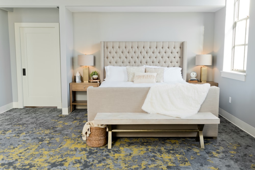 white bed linen on brown wooden bed frame