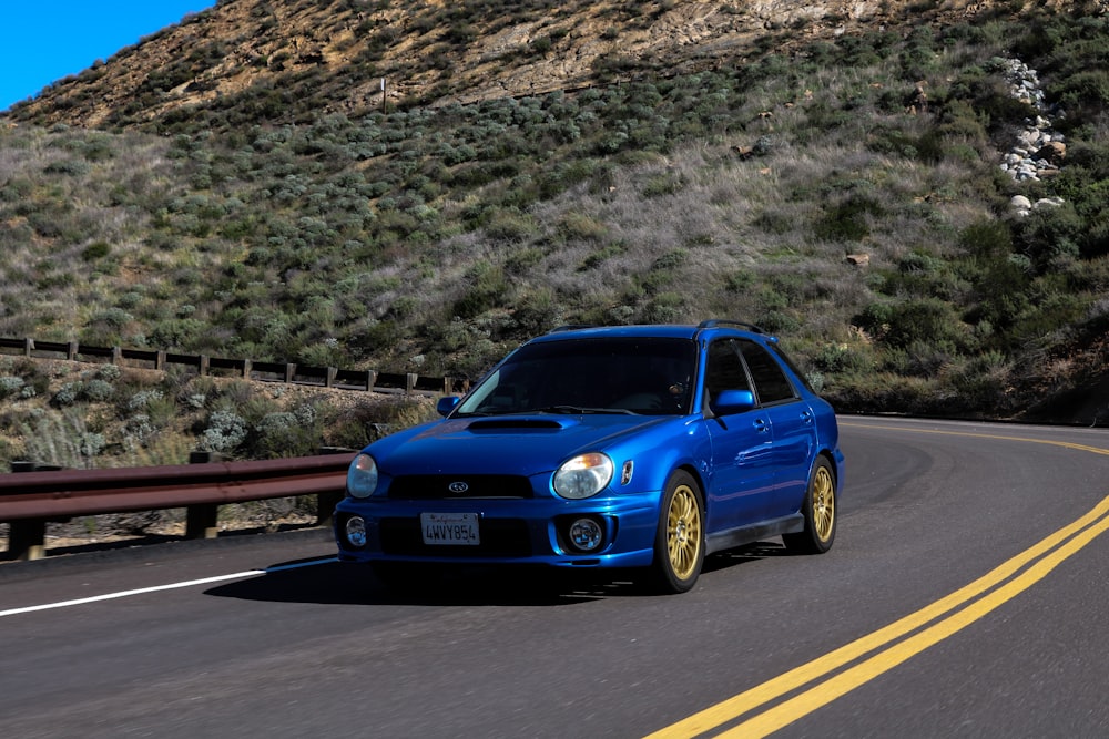 blue audi a 4 on road during daytime