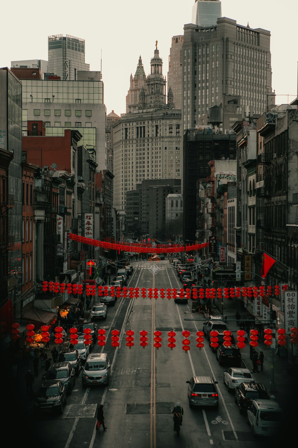 cars on road between high rise buildings during daytime