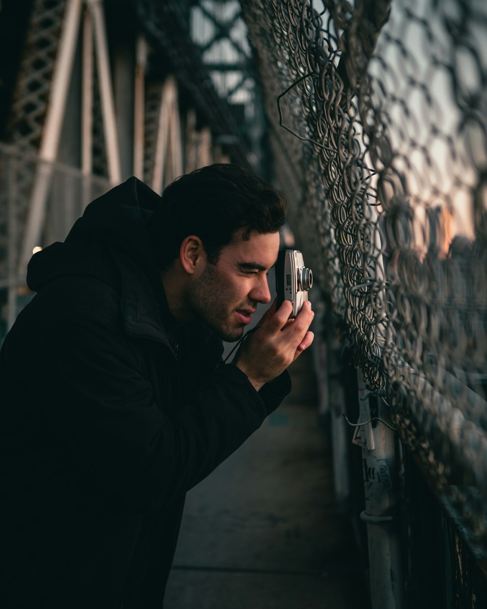 man in black jacket holding smartphone