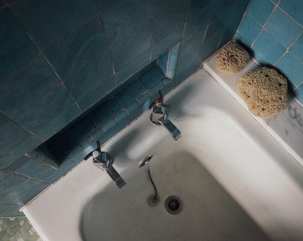 white ceramic sink with stainless steel faucet