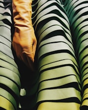 Close-up of durable tactical gloves resting on rugged camouflage fabric.