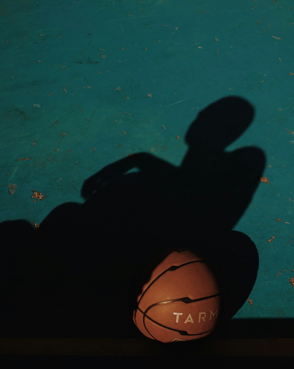 black and brown basketball on blue surface