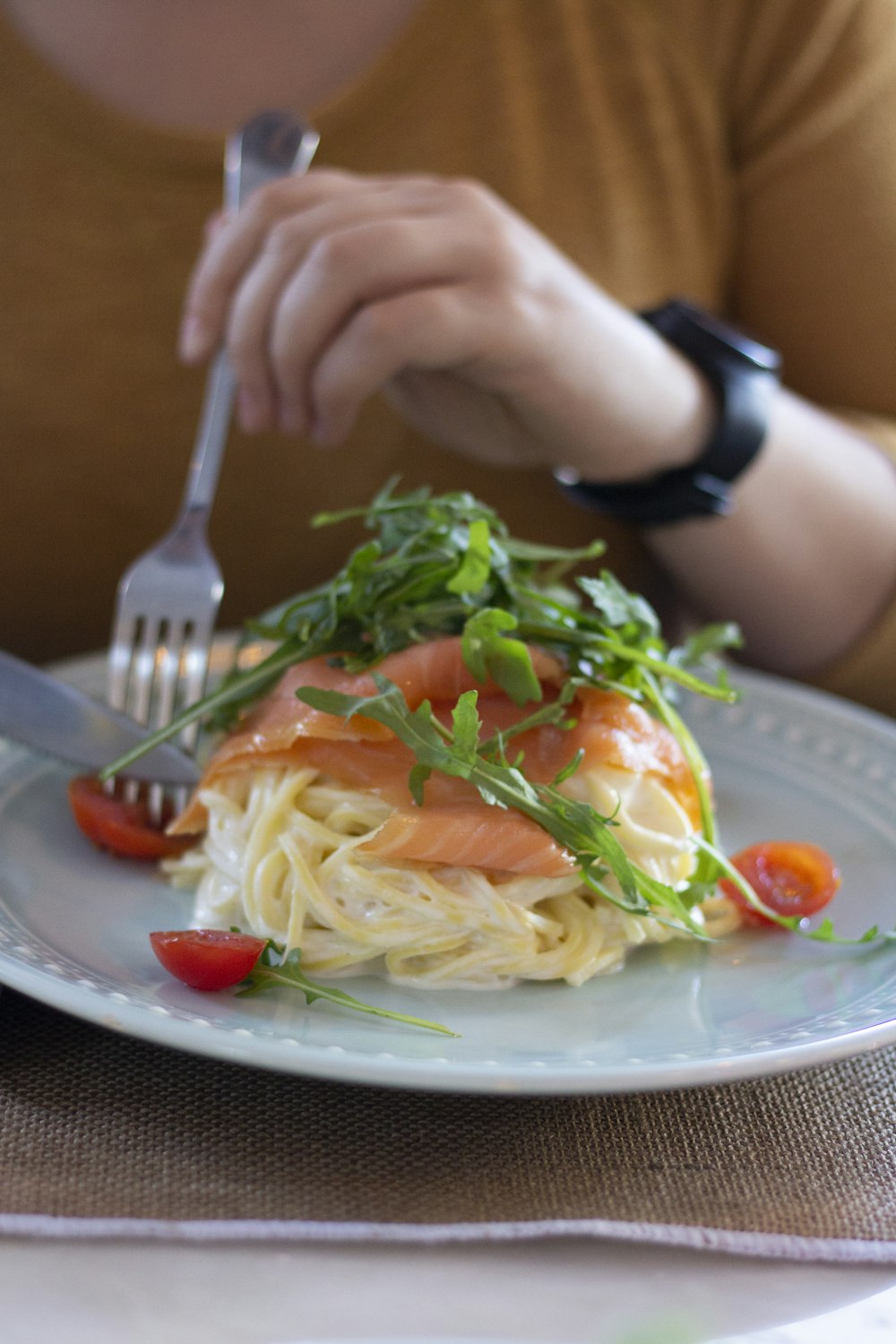 person holding stainless steel fork