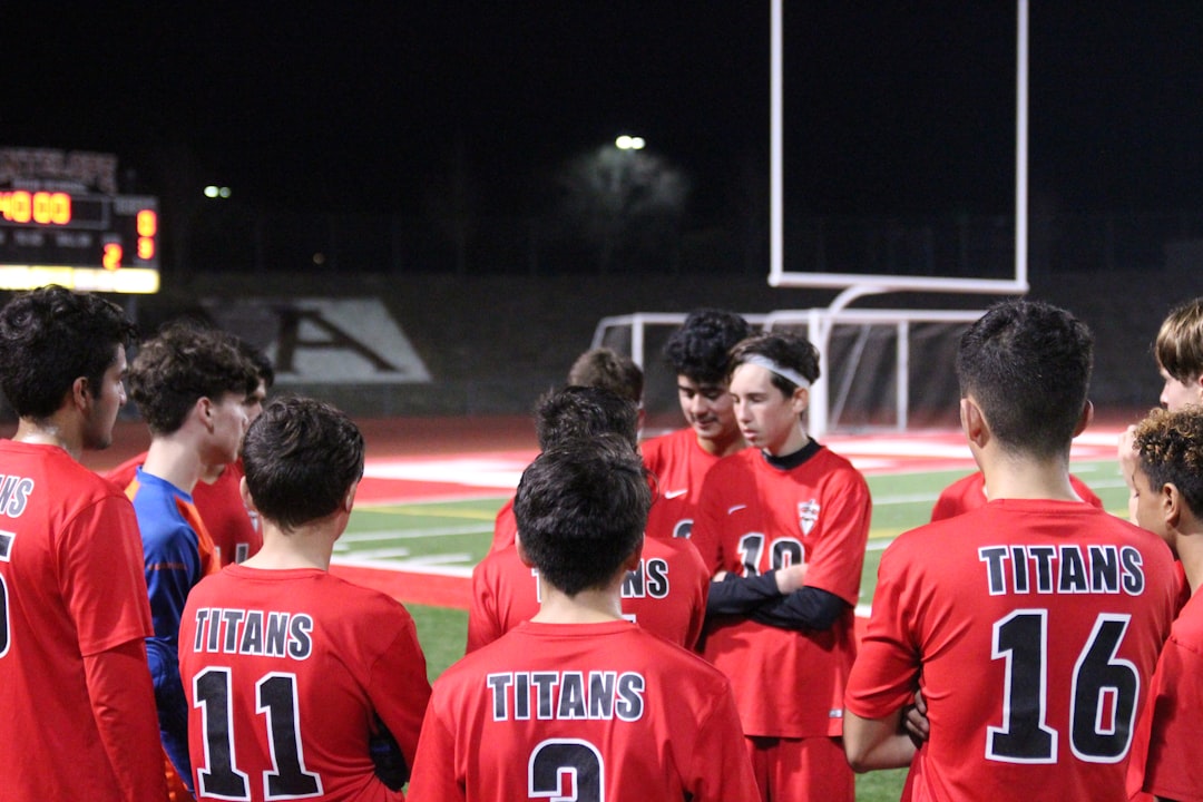 Soccer players in a circle talking - How do soccer players communicate?