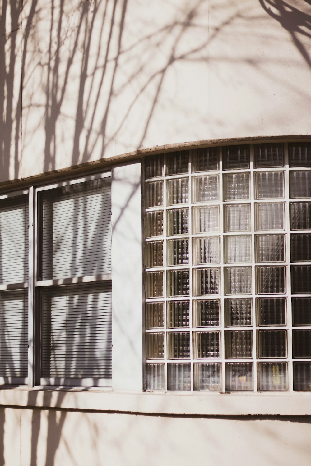 white concrete building with blue window