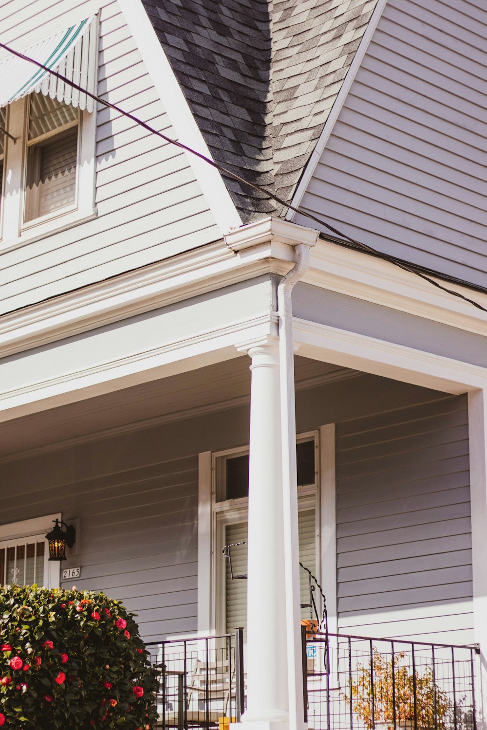 white and gray house with white window blinds