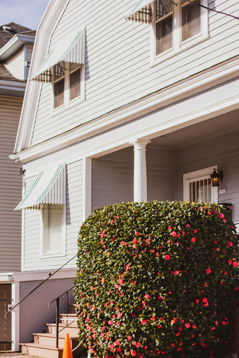 House exterior freshly painted in bright red, white, and blue with clean lines and smooth finish.