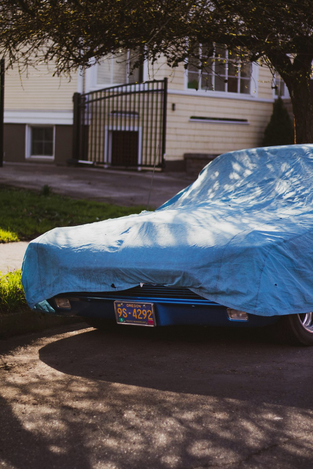 blue car covered with blue textile