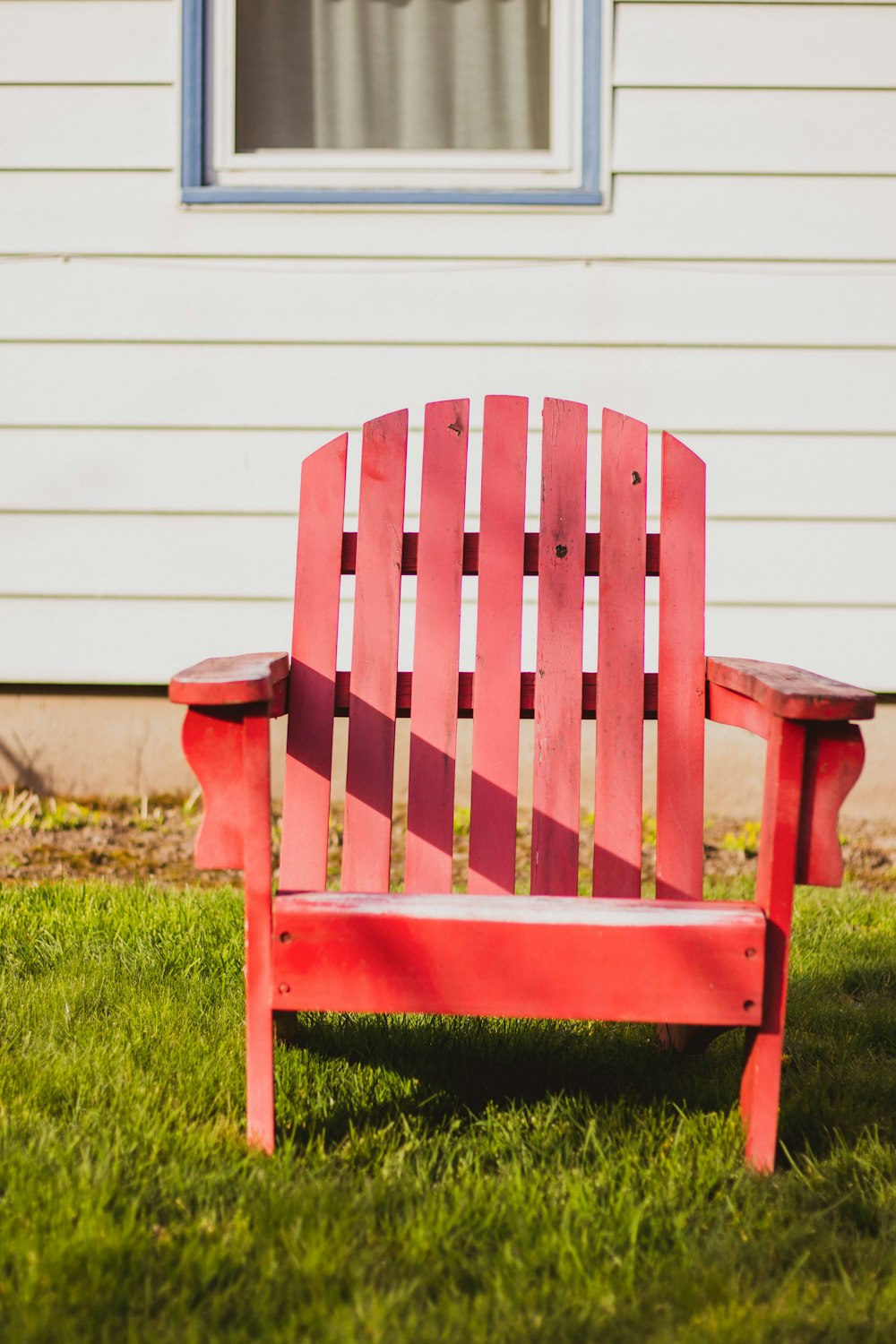 white and blue striped armchair on green grass field