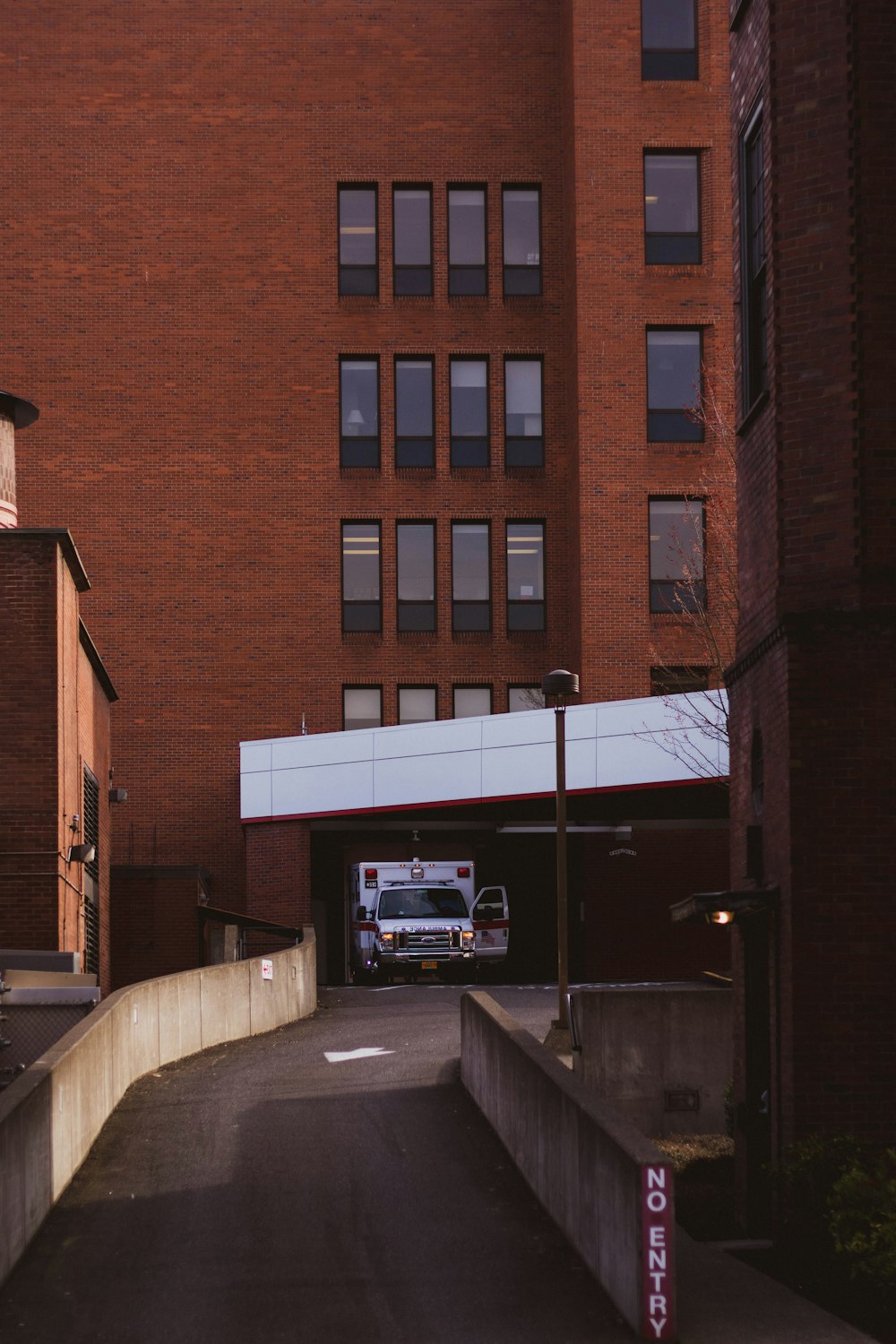 white van parked beside brown building