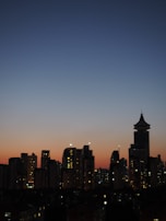 Evening city skyline with a subtle overlay of Lumina Apparel’s logo, blending fashion with urban life.