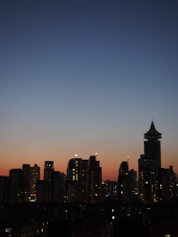 A rising arrow graph overlaying a bustling city skyline at sunset.