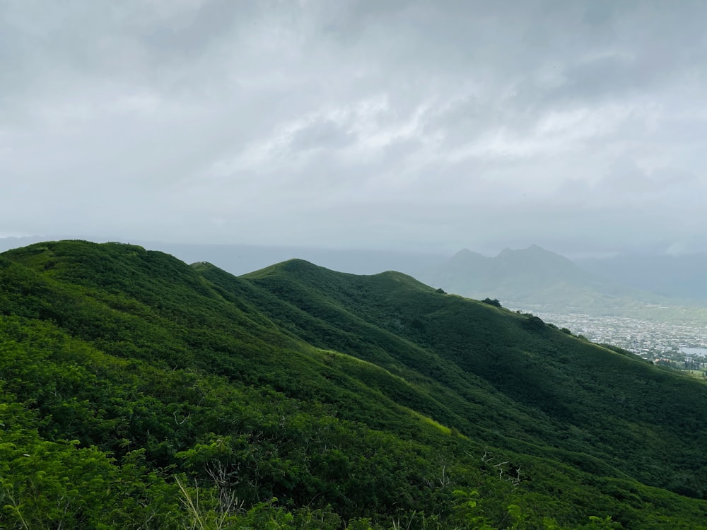 green mountain under white clouds during daytime