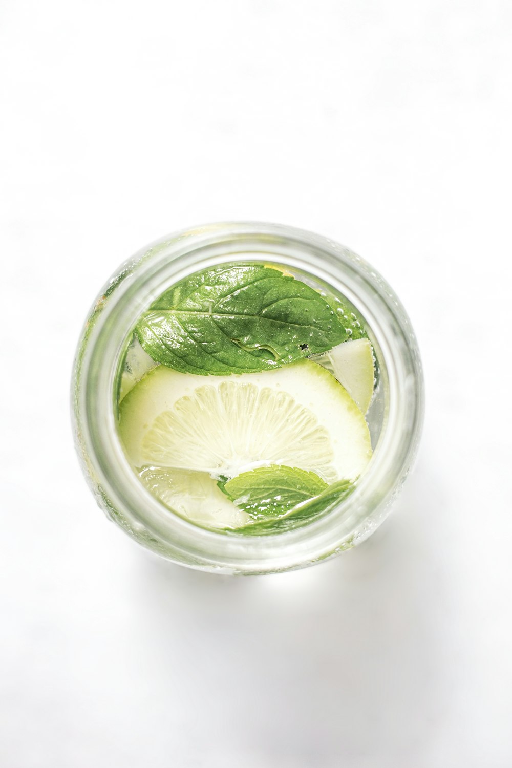 green leaf in clear glass cup