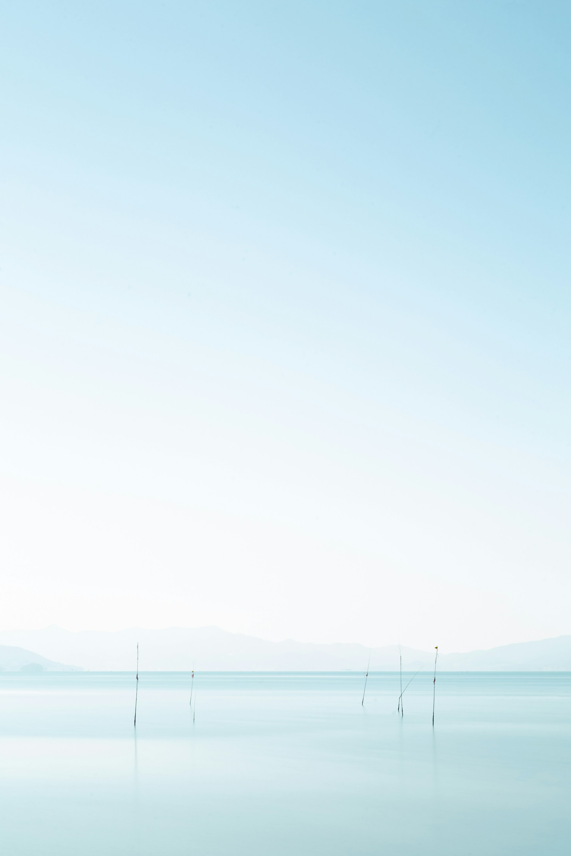 body of water near mountain during daytime