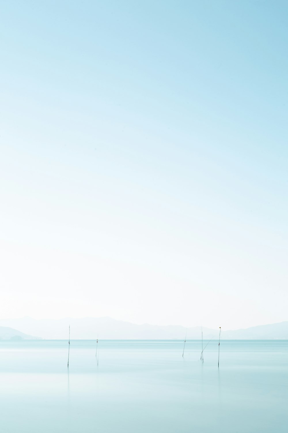 body of water near mountain during daytime